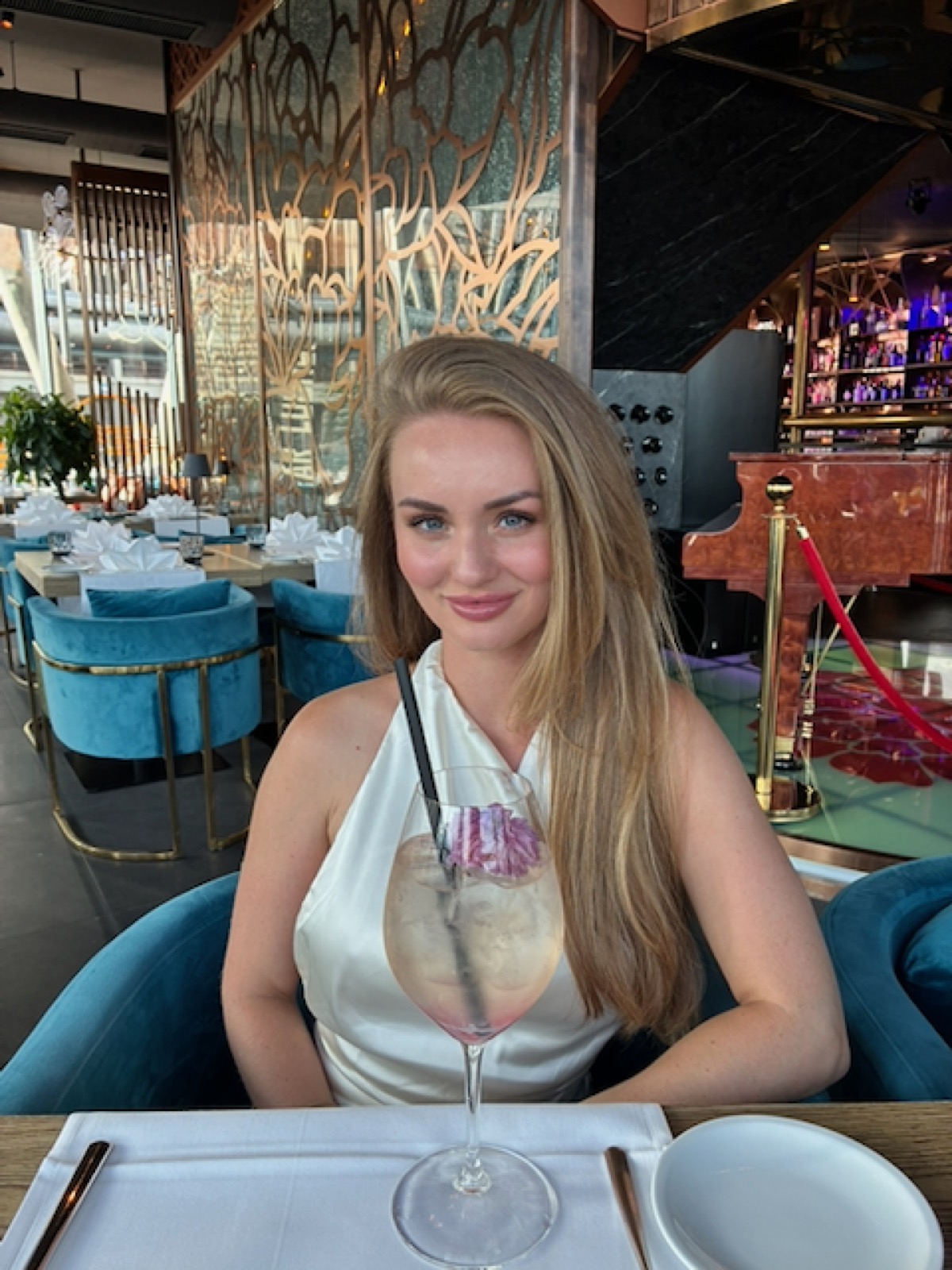 Portrait of a woman smiling at a restaurant table